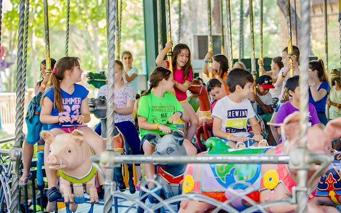 Children enjoying a carousel ride at Parque de Atracciones de Madrid.