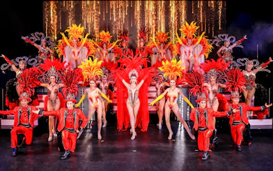 Performers in vibrant costumes on stage at Simon Cabaret Show, Phuket.