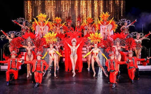 Performers in vibrant costumes on stage at Simon Cabaret Show, Phuket.