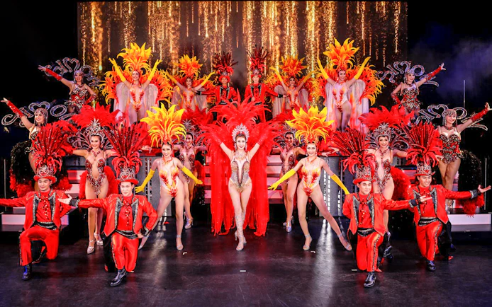 Performers in vibrant costumes on stage at Simon Cabaret Show, Phuket.