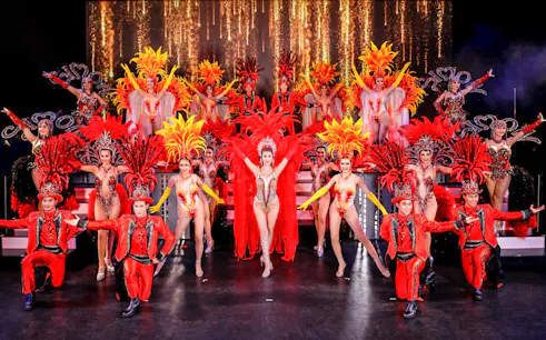 Performers in vibrant costumes on stage at Simon Cabaret Show, Phuket.