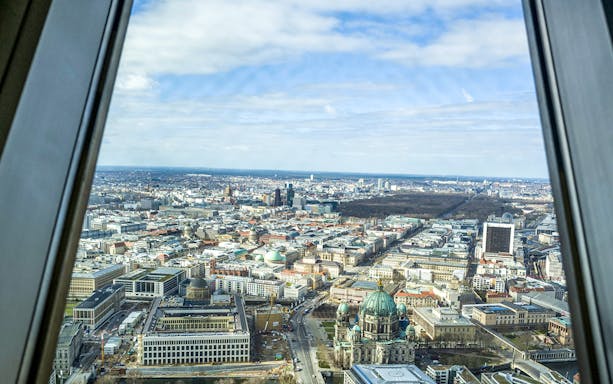 View of Berlin cityscape from the TV tower, featuring Berlin Cathedral and surrounding architecture.