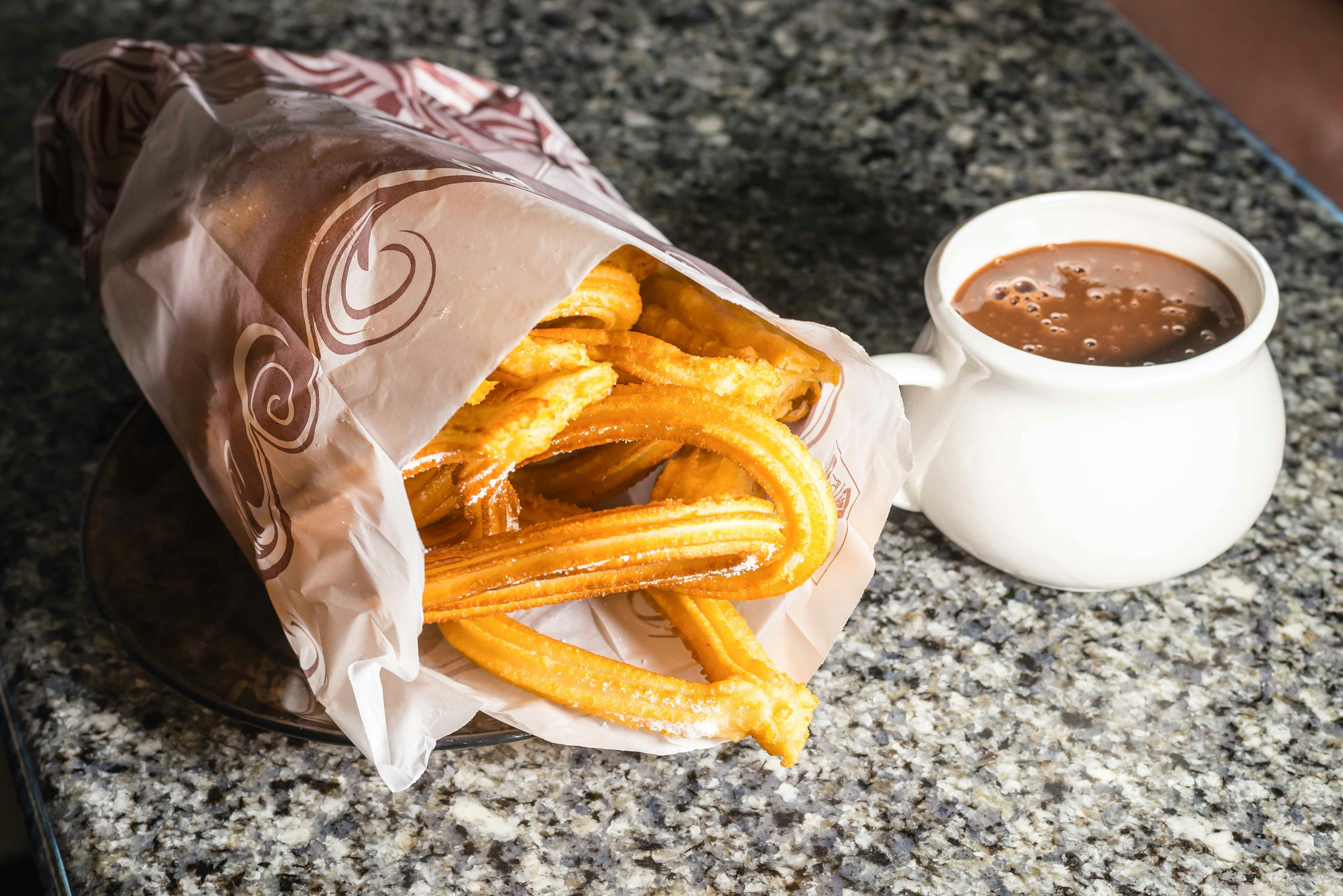 Churros with hot chocolate on a table in Madrid.