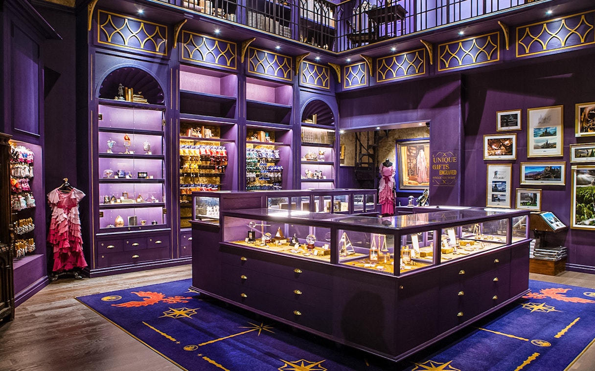 Harry Potter studio shop in London with purple displays and merchandise.