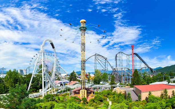 Wide-angle view of FujiQ Highlands theme park in Japan with roller coasters and attractions.