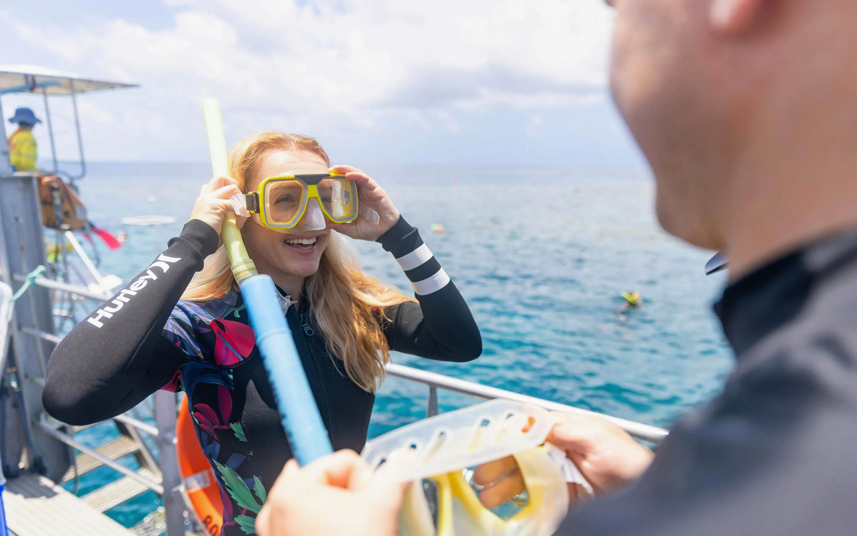 Snorkeler preparing for Sunlover Reef Cruises tour at Great Barrier Reef.