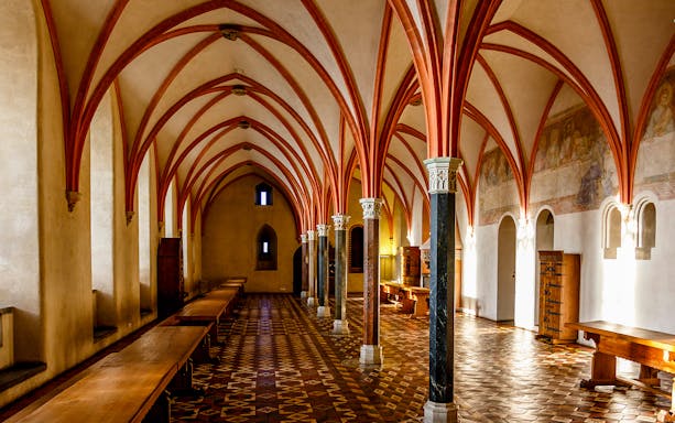 Malbork Castle interior with vaulted ceilings and medieval decor.