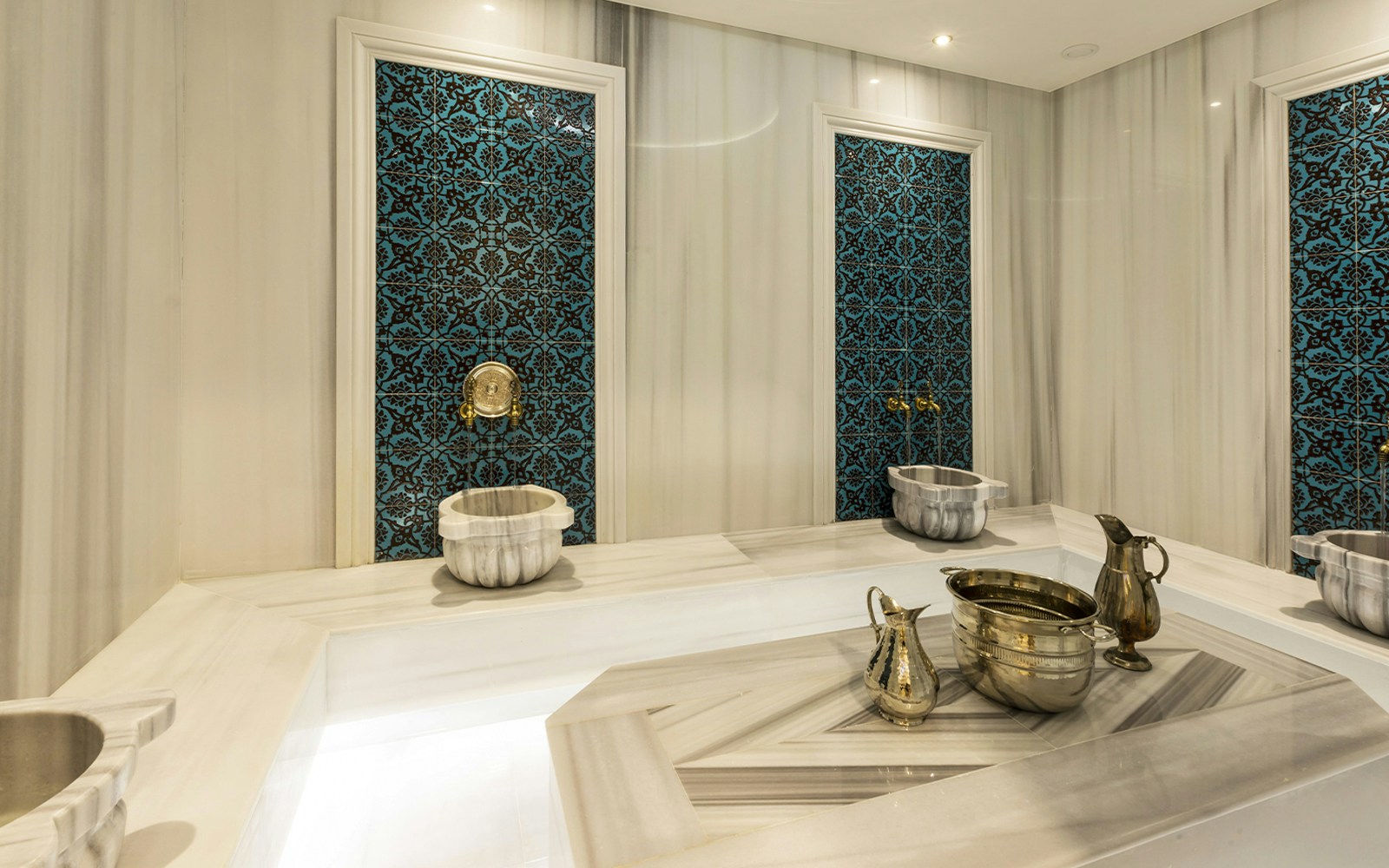 Turkish bath interior with marble basin and towel in Taksim, Istanbul, spa and massage experience.