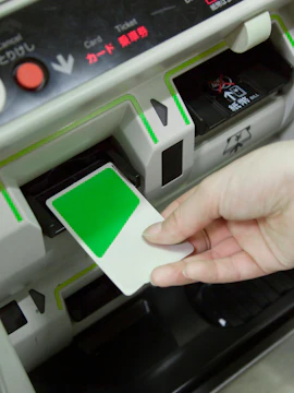 Inserting Suica IC Card into ticket machine in Japan.