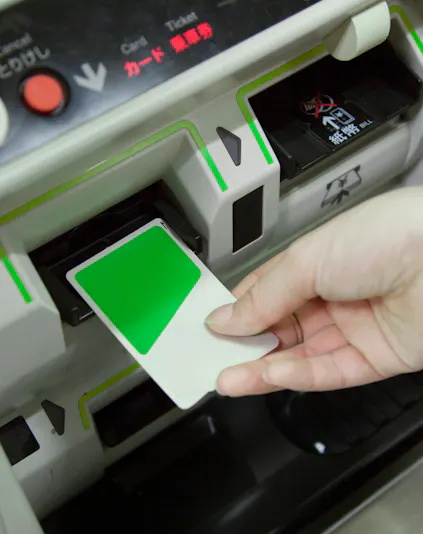 Inserting Suica IC Card into ticket machine in Japan.