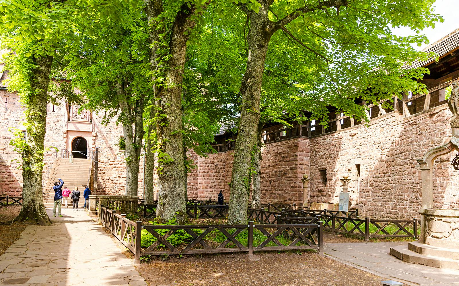 Visitors walking through the courtyard of Haut-Koenigsbourg Castle, Alsace, France.