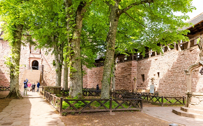 Visitors walking through the courtyard of Haut-Koenigsbourg Castle, Alsace, France.