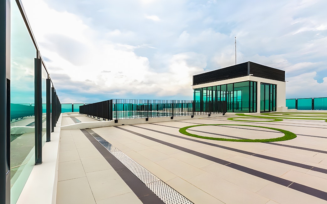 Rooftop view from The Shore Sky Tower with glass railings and modern architecture.