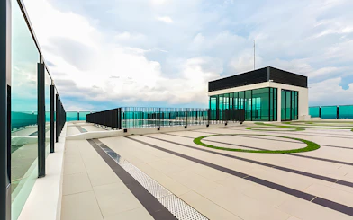 Rooftop view from The Shore Sky Tower with glass railings and modern architecture.