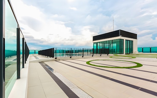 Rooftop view from The Shore Sky Tower with glass railings and modern architecture.