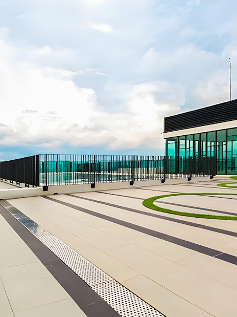 Rooftop view from The Shore Sky Tower with glass railings and modern architecture.
