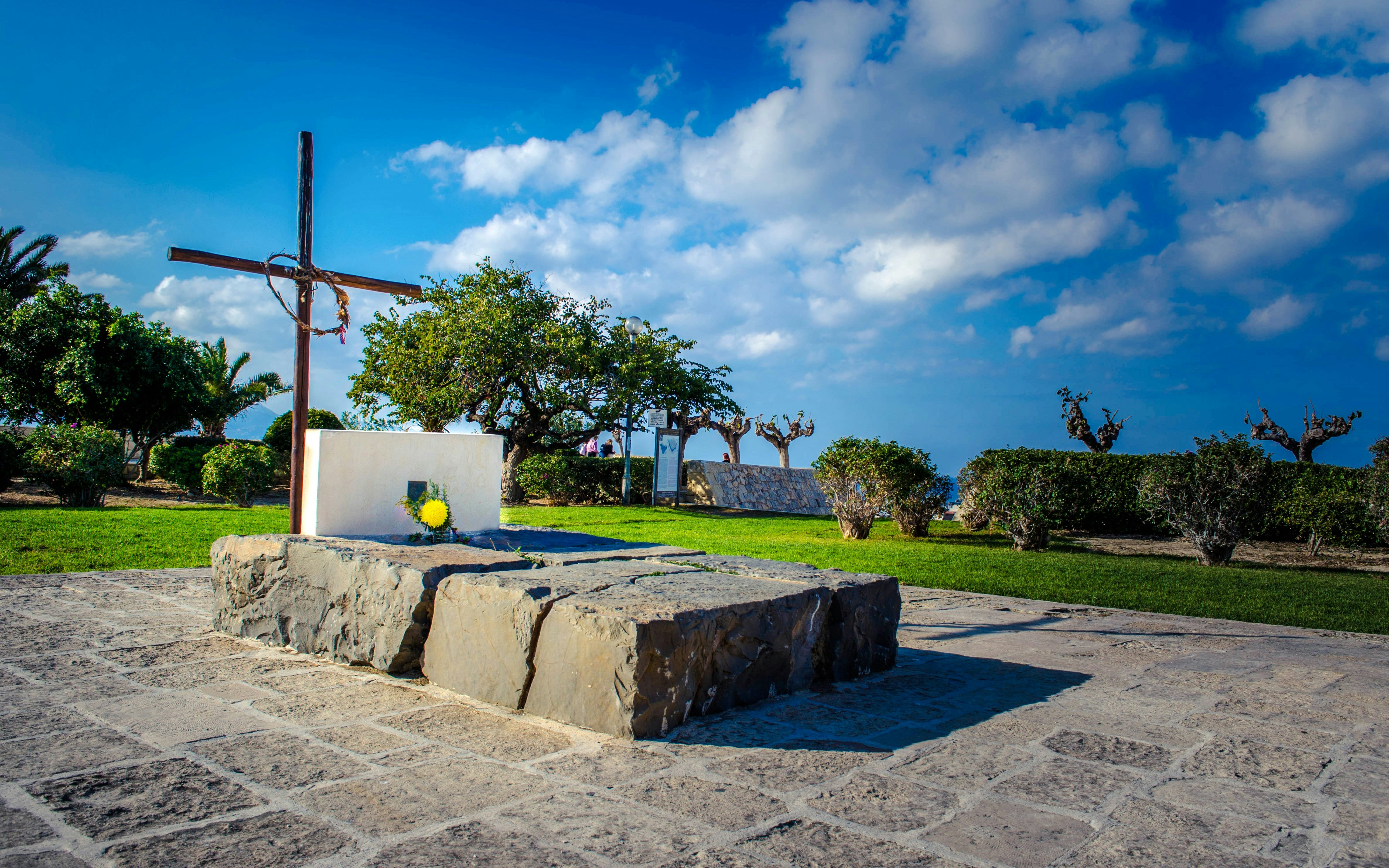 Kazantzakis Grave in Heraklion with cross and stone slab under a blue sky.
