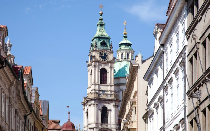 Church of St. Nicholas tower in Mala Strana, Prague, Czech Republic, with surrounding buildings.