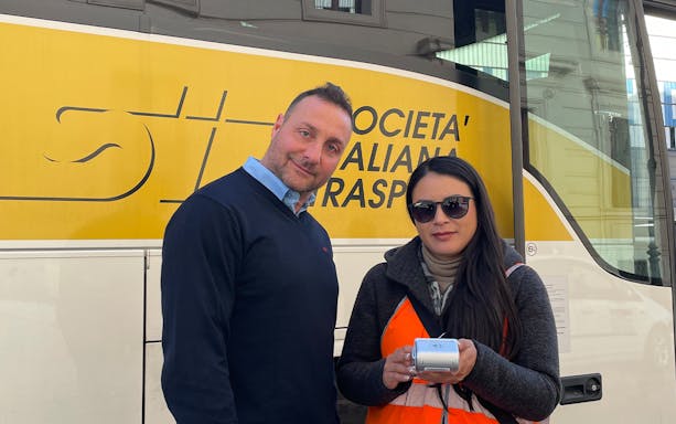 Bus staff assisting with tickets for Rome hop-on hop-off tour.