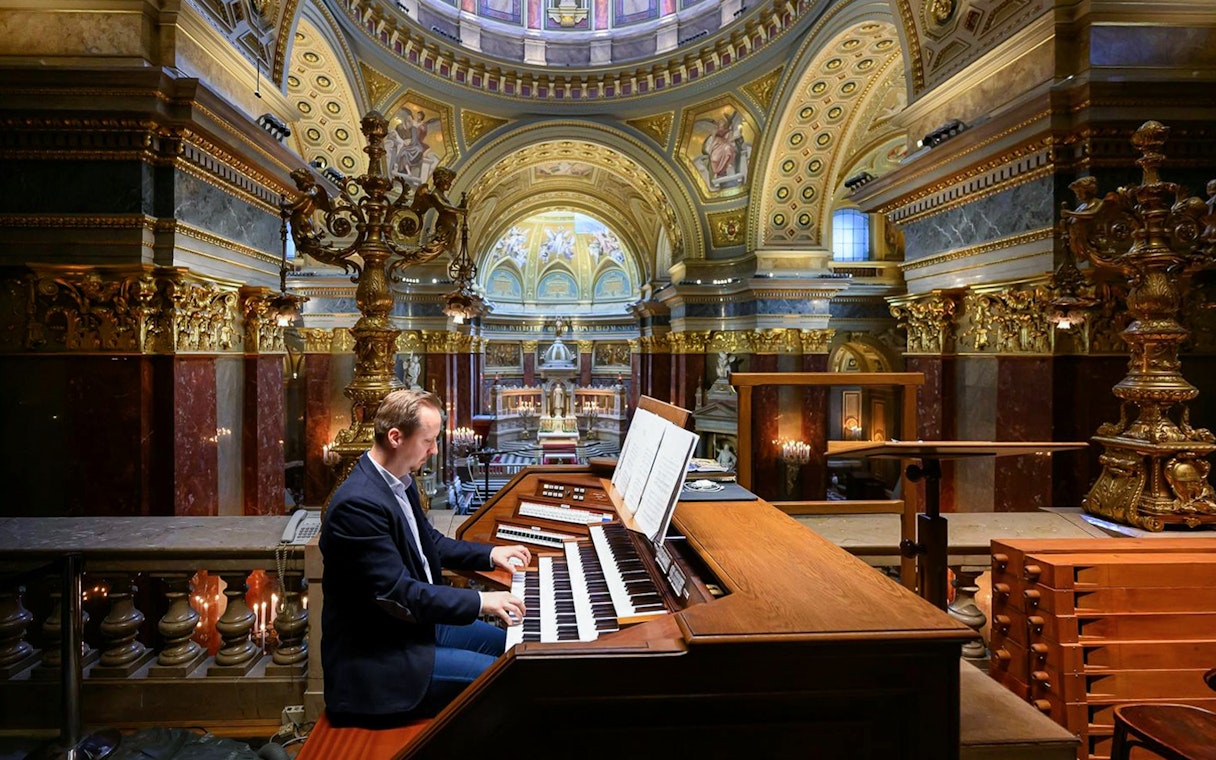 Musician playing the organ inside St. Stephen's Basilica, Budapest.