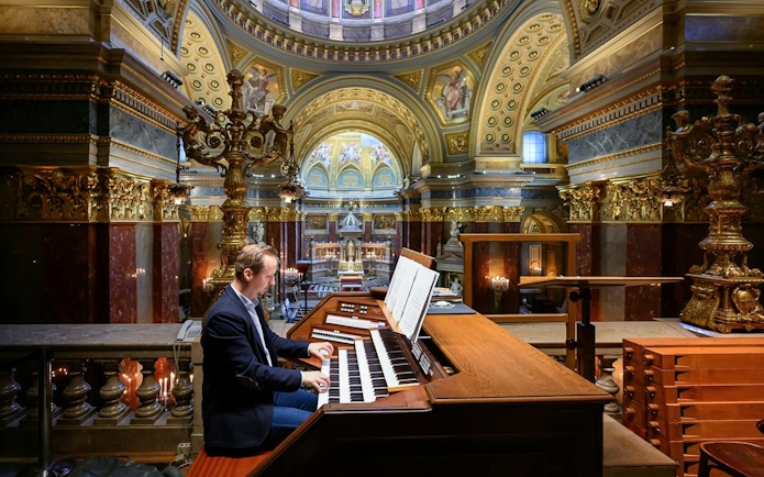 Musician playing the organ inside St. Stephen's Basilica, Budapest.