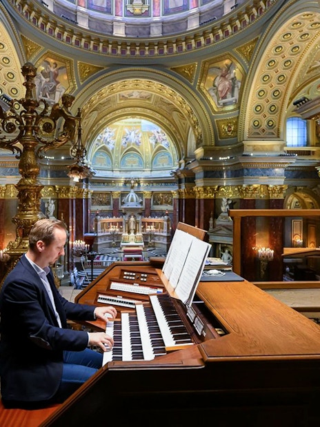 Musician playing the organ inside St. Stephen's Basilica, Budapest.