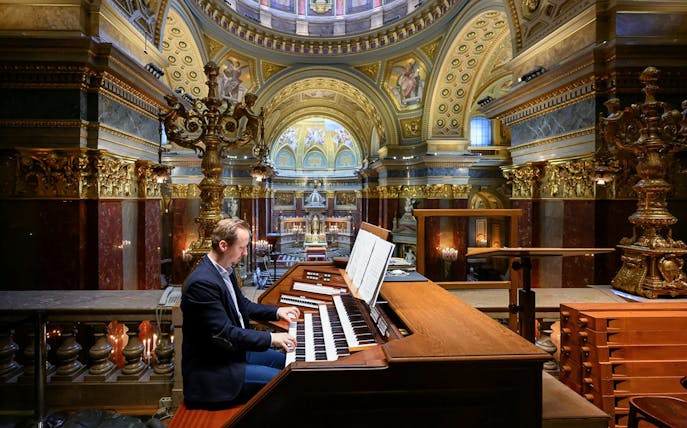 Musician playing the organ inside St. Stephen's Basilica, Budapest.