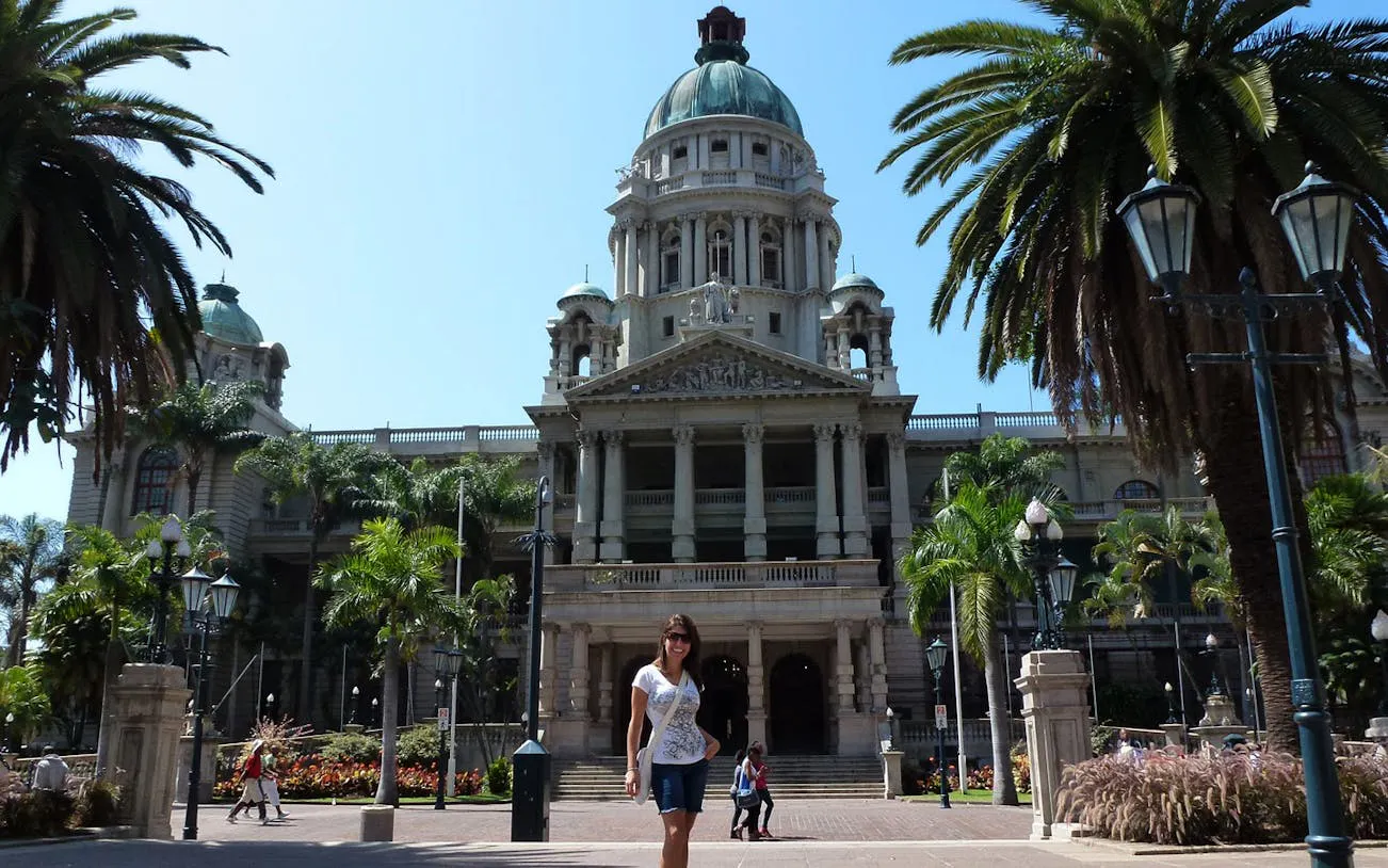 Durban City Hall with palm trees and visitors in front, part of Durban City Tour.