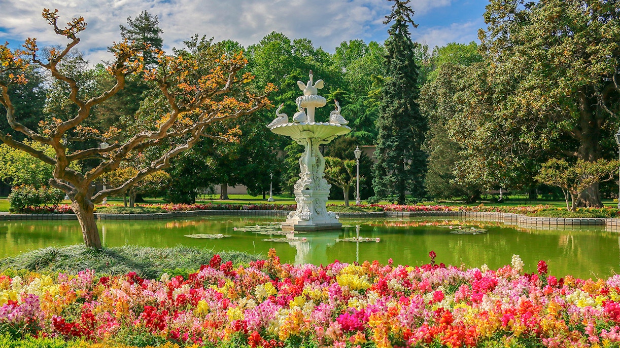 Dolmabahce Palace Gardens' Grand Fountain with surrounding lush greenery in Istanbul, Turkey.