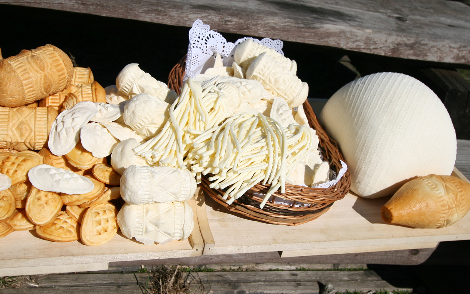 Assorted traditional cheeses from Zakopane displayed in a basket.