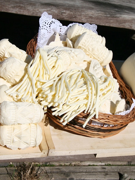 Assorted traditional cheeses from Zakopane displayed in a basket.