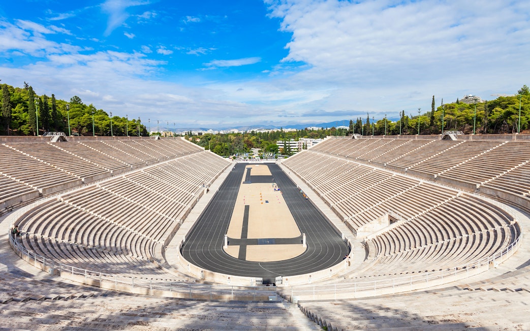 Panathenaic Stadium in Athens, Greece, with empty marble stands and a central track.