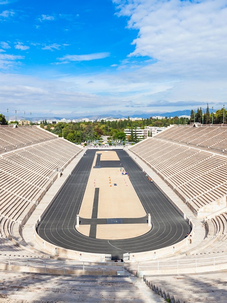 Panathenaic Stadium in Athens, Greece, with empty marble stands and a central track.
