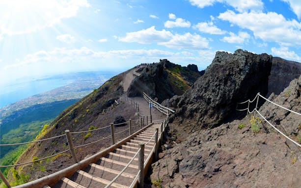 Pathway along Mt. Vesuvius crater with view of Naples coastline.