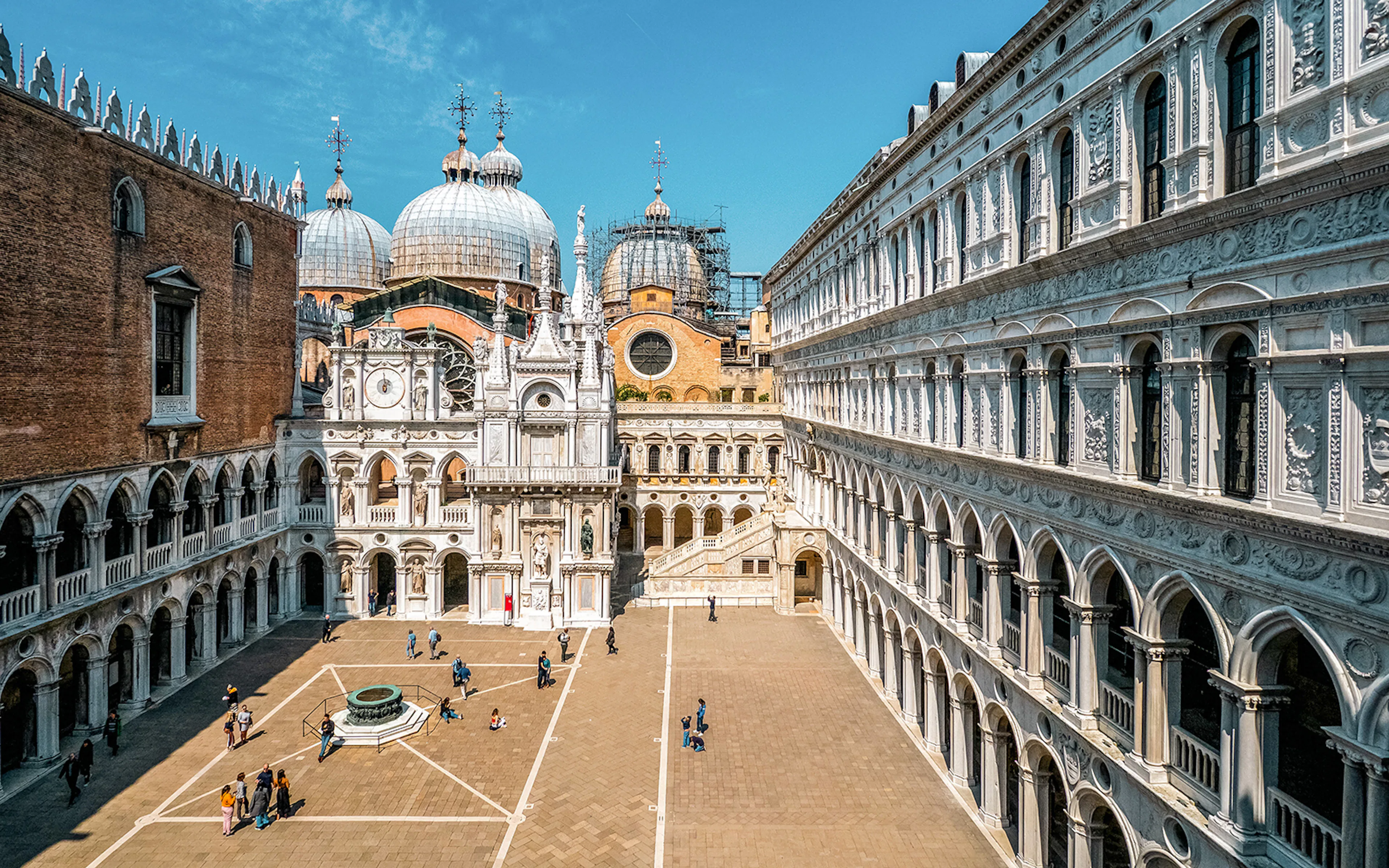 Cloister of Doge’s Palace courtyard with ornate arches and domes, Venice.