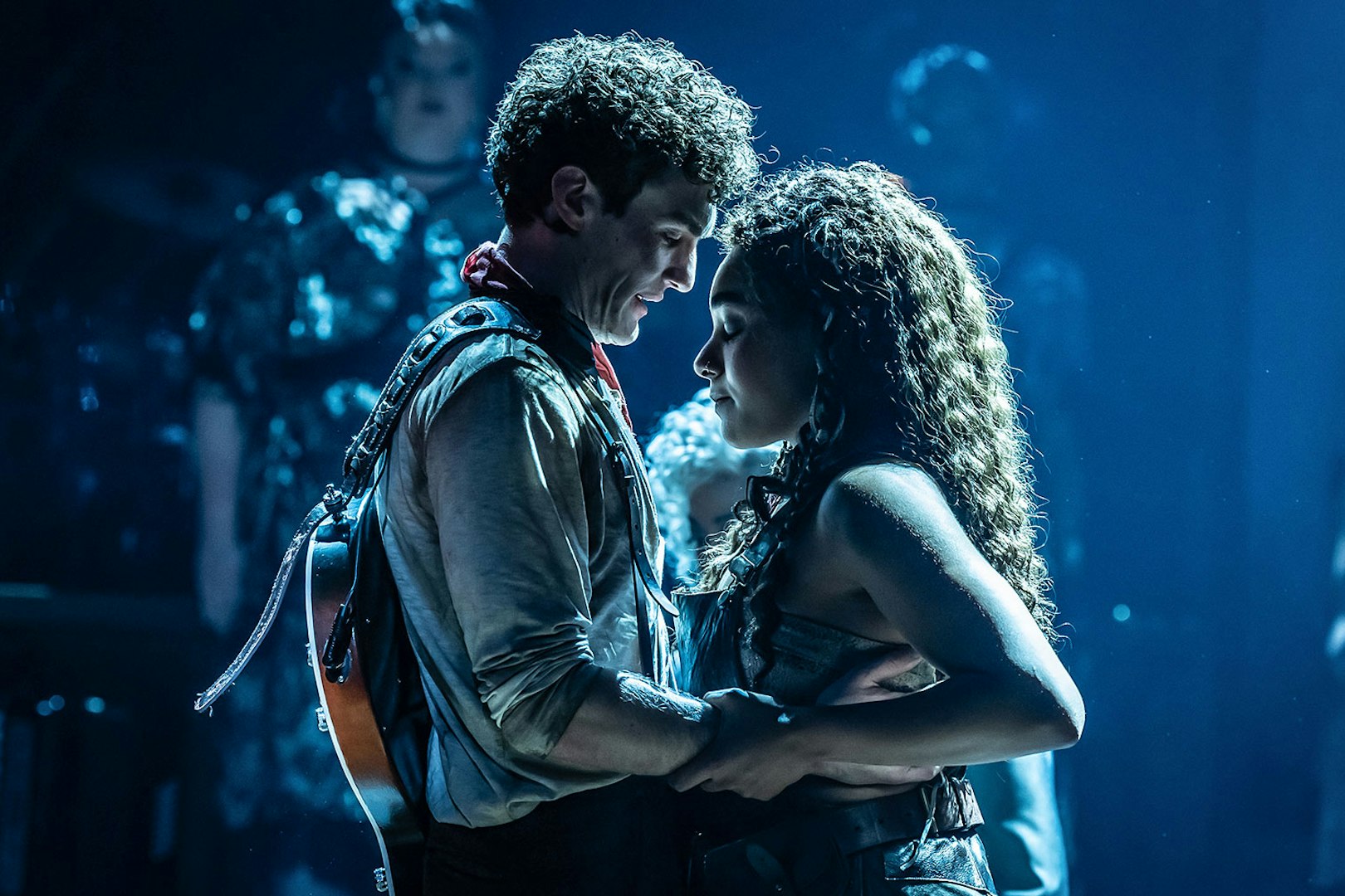 Performers embracing on stage during Hadestown musical.