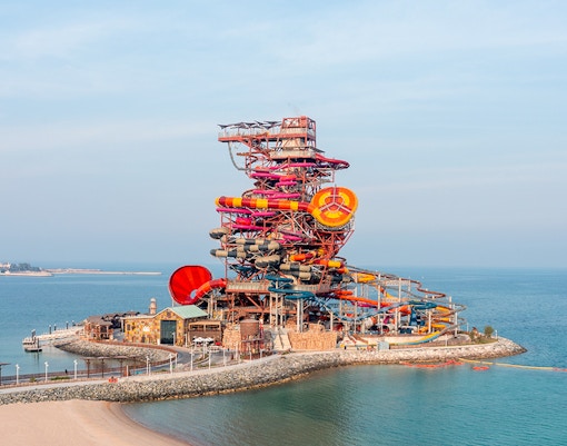 Meryal Waterpark Rig 1938 with colorful water slides by the sea.