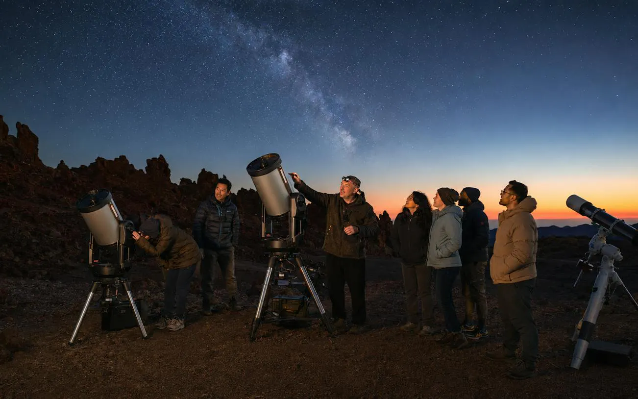 Group stargazing with telescopes at sunset in Teide National Park, Tenerife.