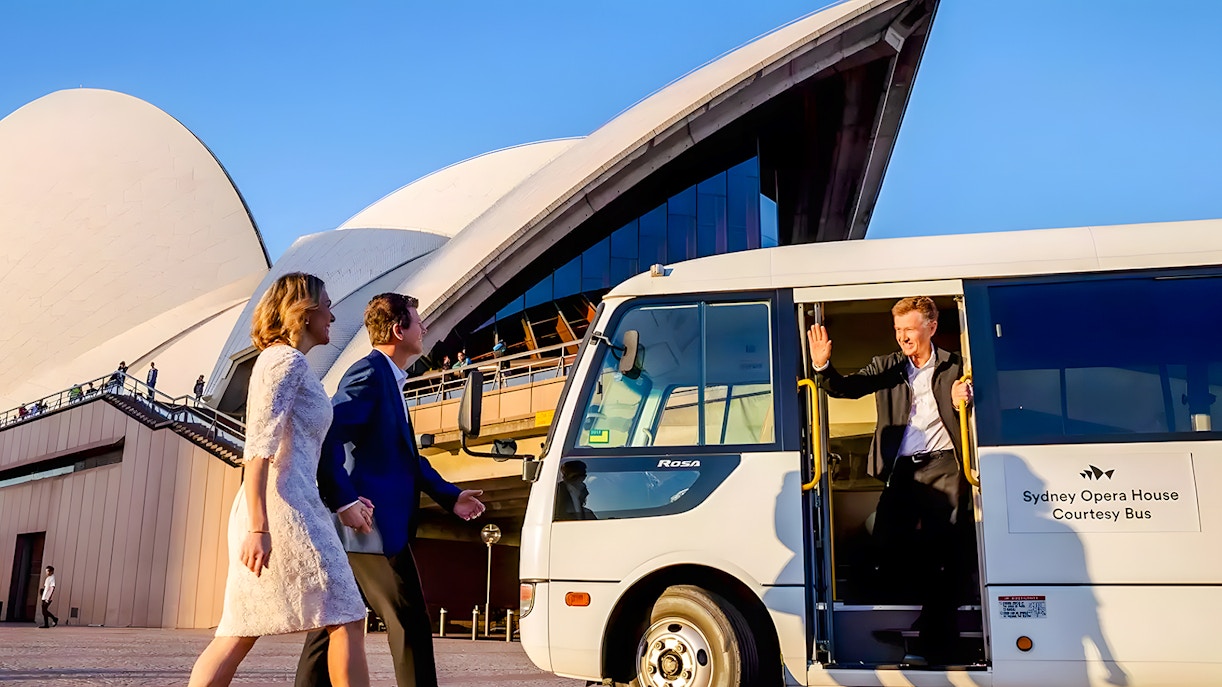 Shuttle bus arriving at Sydney Opera House with passengers.