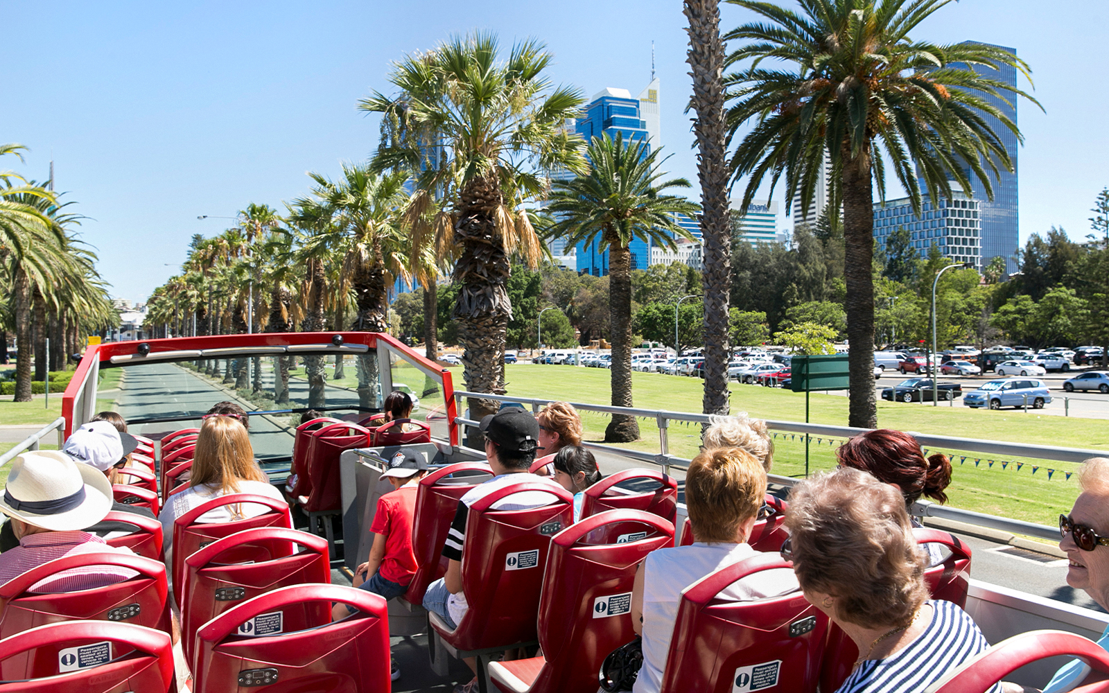 Open-top bus tour through Kings Park, Perth, with passengers enjoying city views.