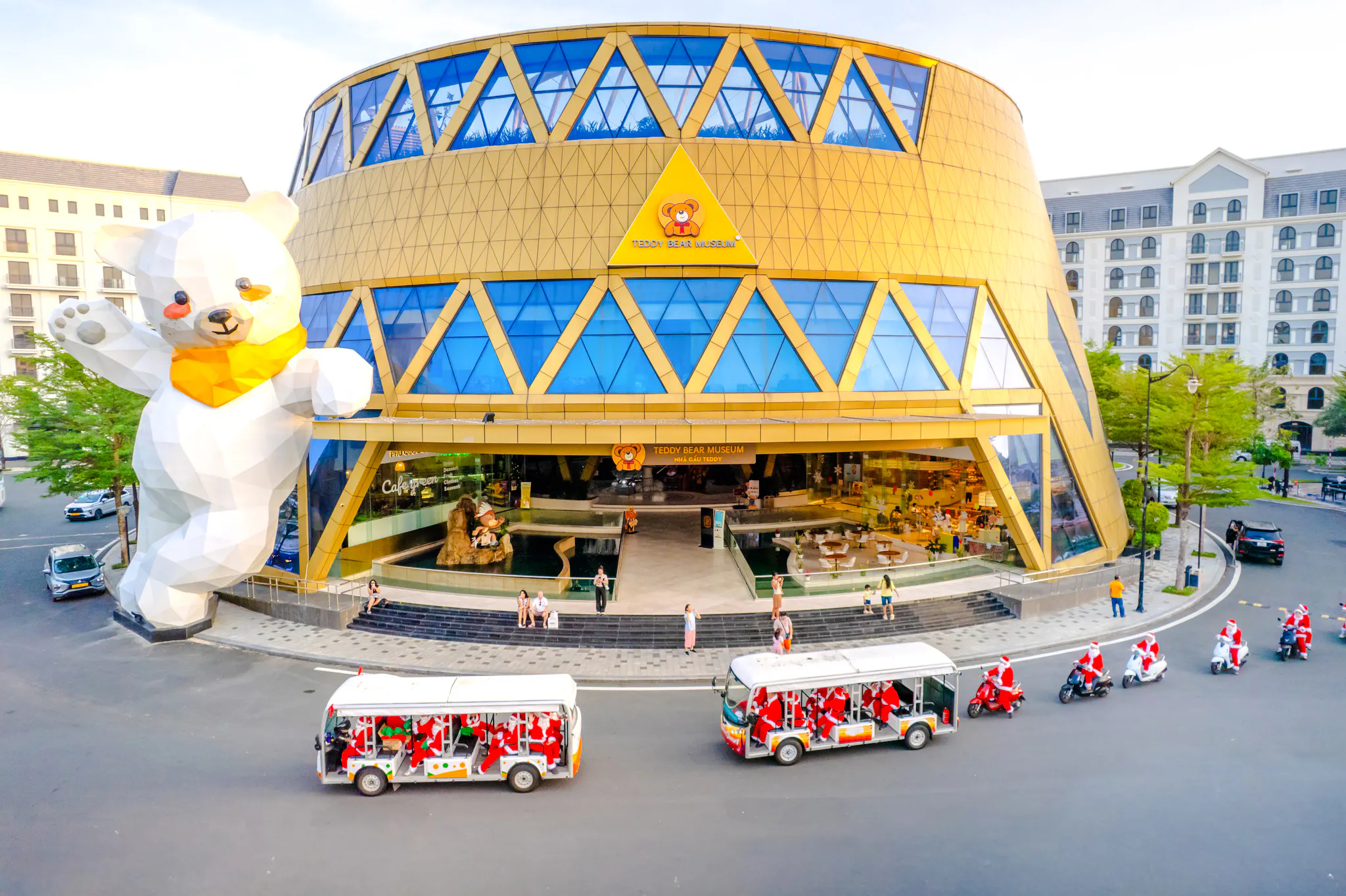Teddy Bear Museum entrance with tour buses and scooters, Phu Quoc VinWonders.