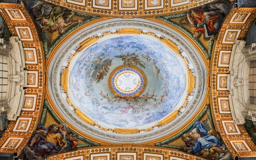 Ceiling fresco inside St. Peter’s Basilica, Vatican City, depicting religious figures and ornate details.