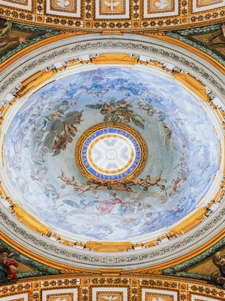 Ceiling fresco inside St. Peter’s Basilica, Vatican City, depicting religious figures and ornate details.