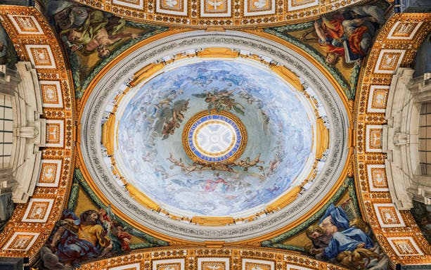 Ceiling fresco inside St. Peter’s Basilica, Vatican City, depicting religious figures and ornate details.