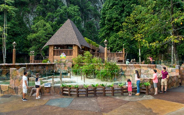 Visitors exploring Sunway Lost World of Tambun's animal exhibit in Malaysia.
