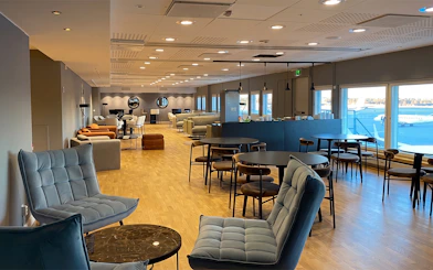Pearl Lounge seating area with airport runway view at Stockholm Arlanda Terminal 2.