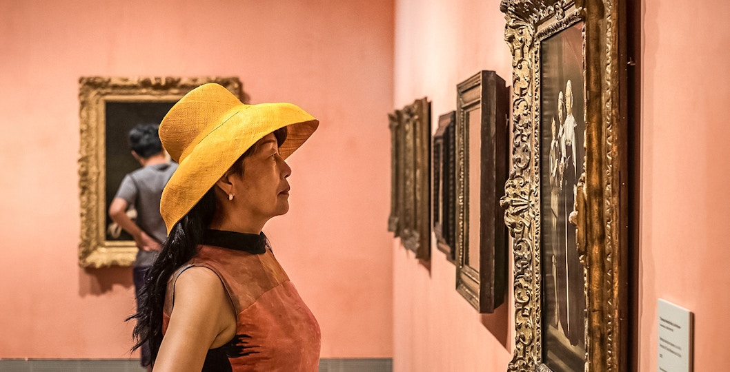 Visitors viewing historical paintings at Thyssen Bornemisza Museum, Madrid.