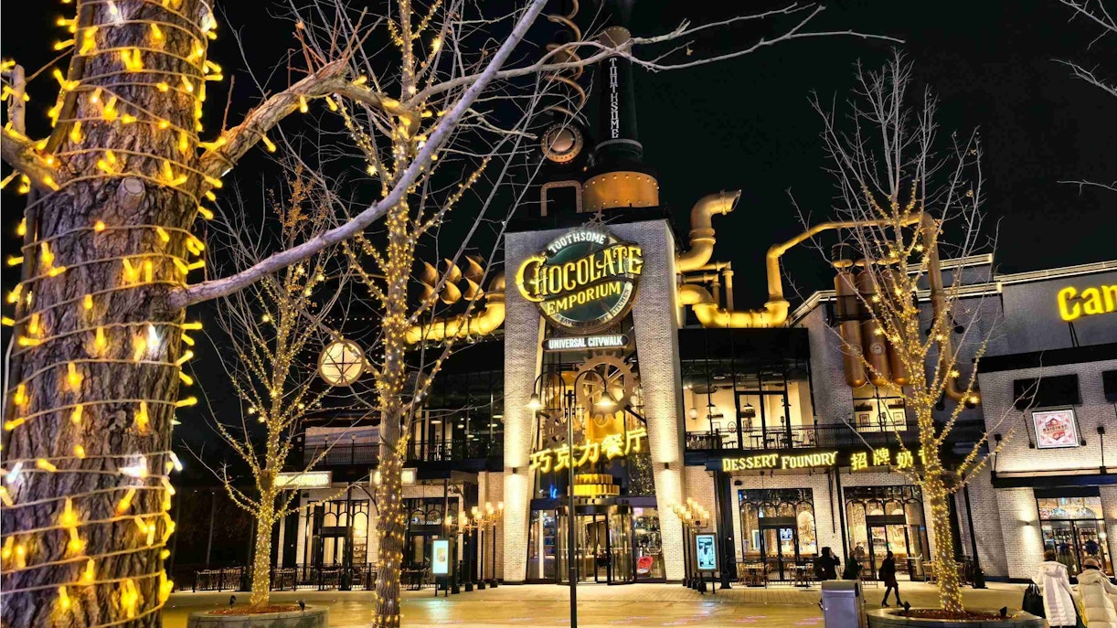 Toothsome Chocolate Emporium at Universal Studios CityWalk Beijing illuminated at night.