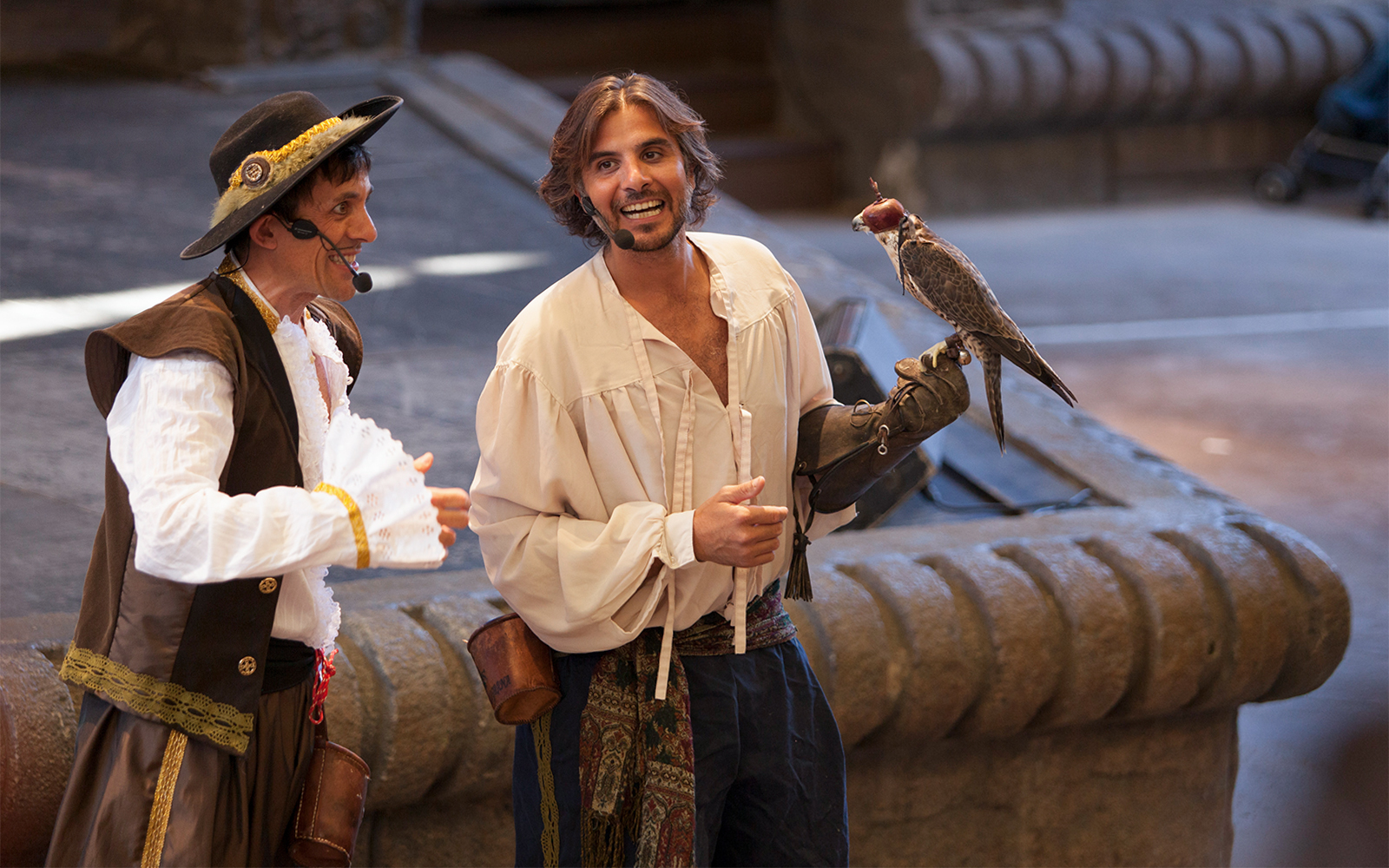 Falconry show at Isla Mágica with performers in period costumes.