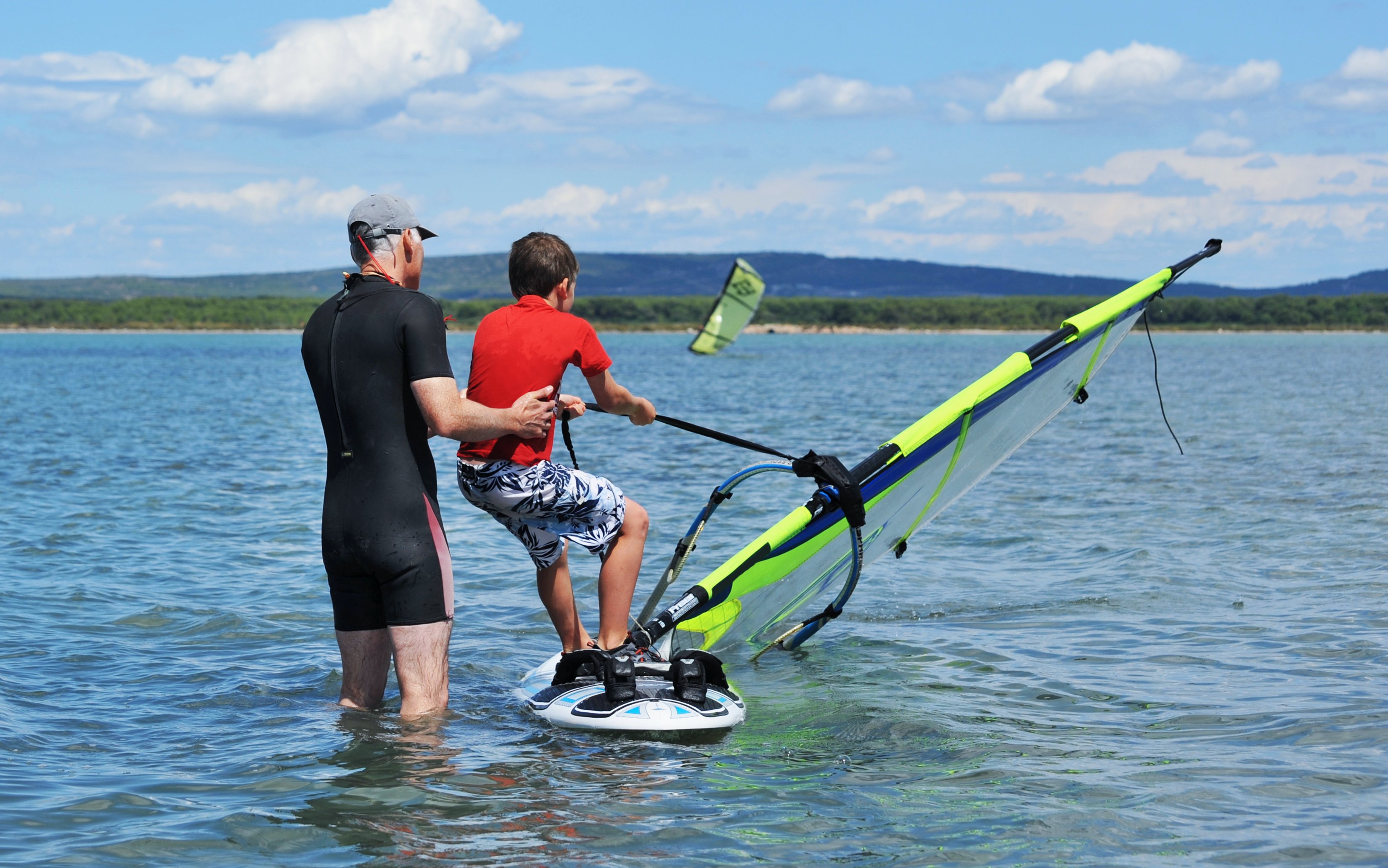 Windsurfing lesson with instructor and child in Delta Neretva, Croatia.